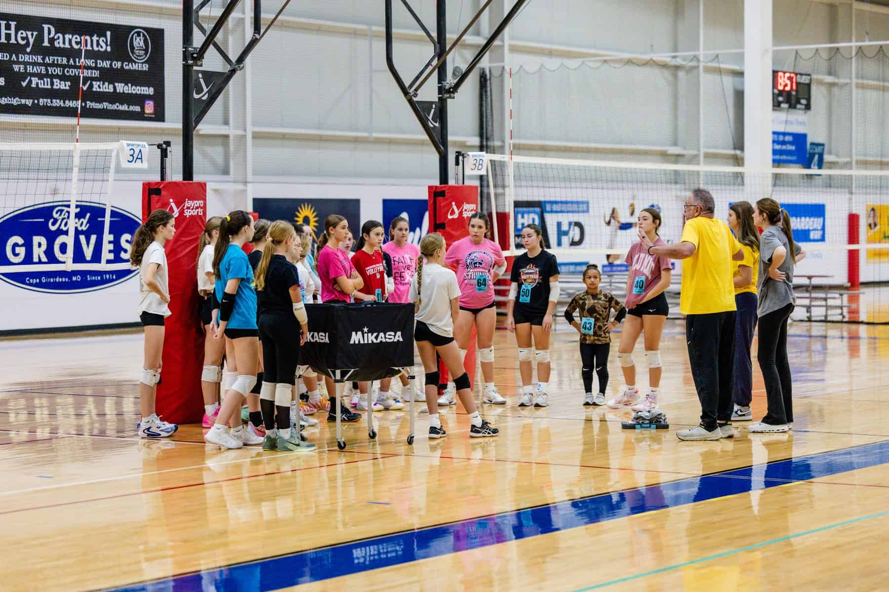 Coaches huddle with athletes at NSSC youth volleyball tryouts in Cape Girardeau