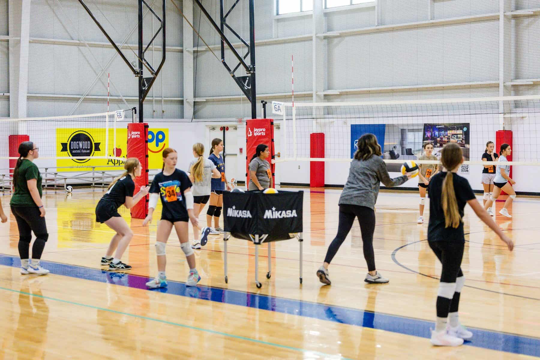 Athletes rotate through passing stations at NSSC youth volleyball tryouts